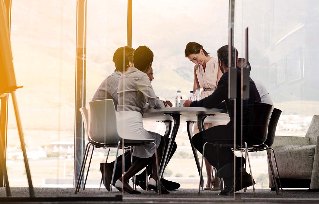 Image of four people around a table