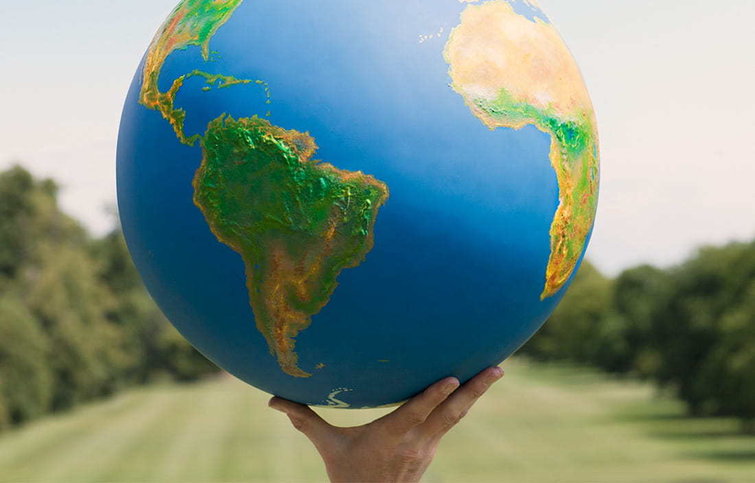 Hand holding a globe