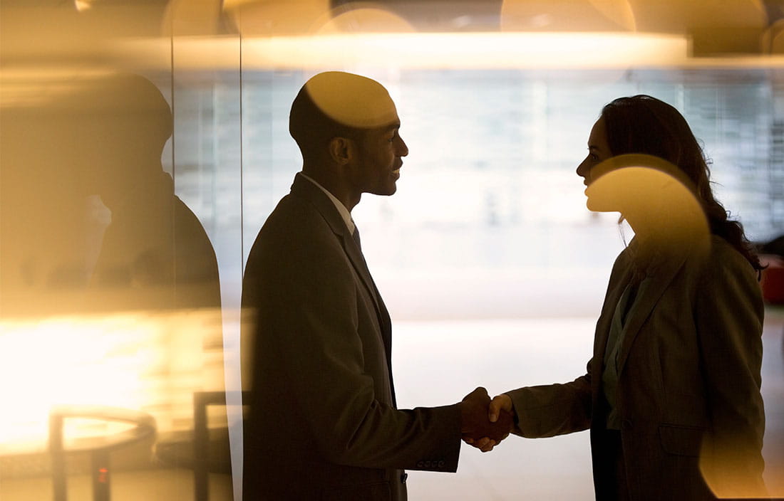 Image of two people shaking hands