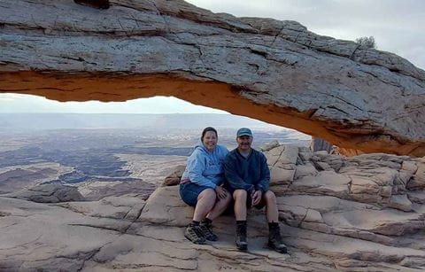 Couple sitting together in a nature scenic shot.