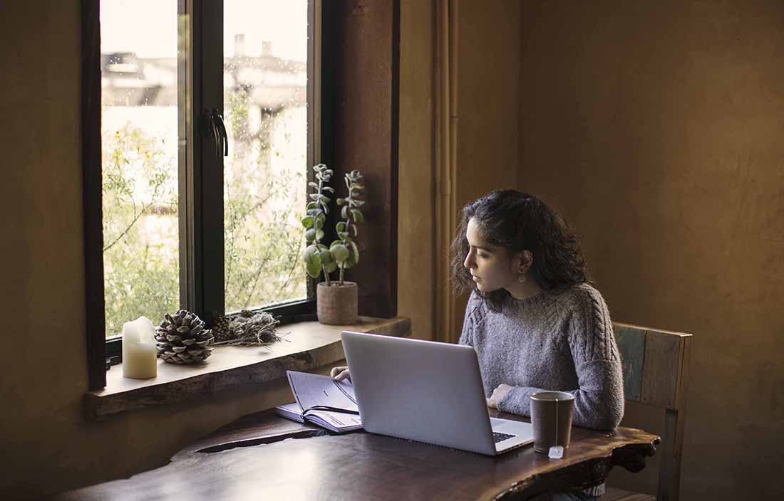 Woman sitting at a desk with her laptop