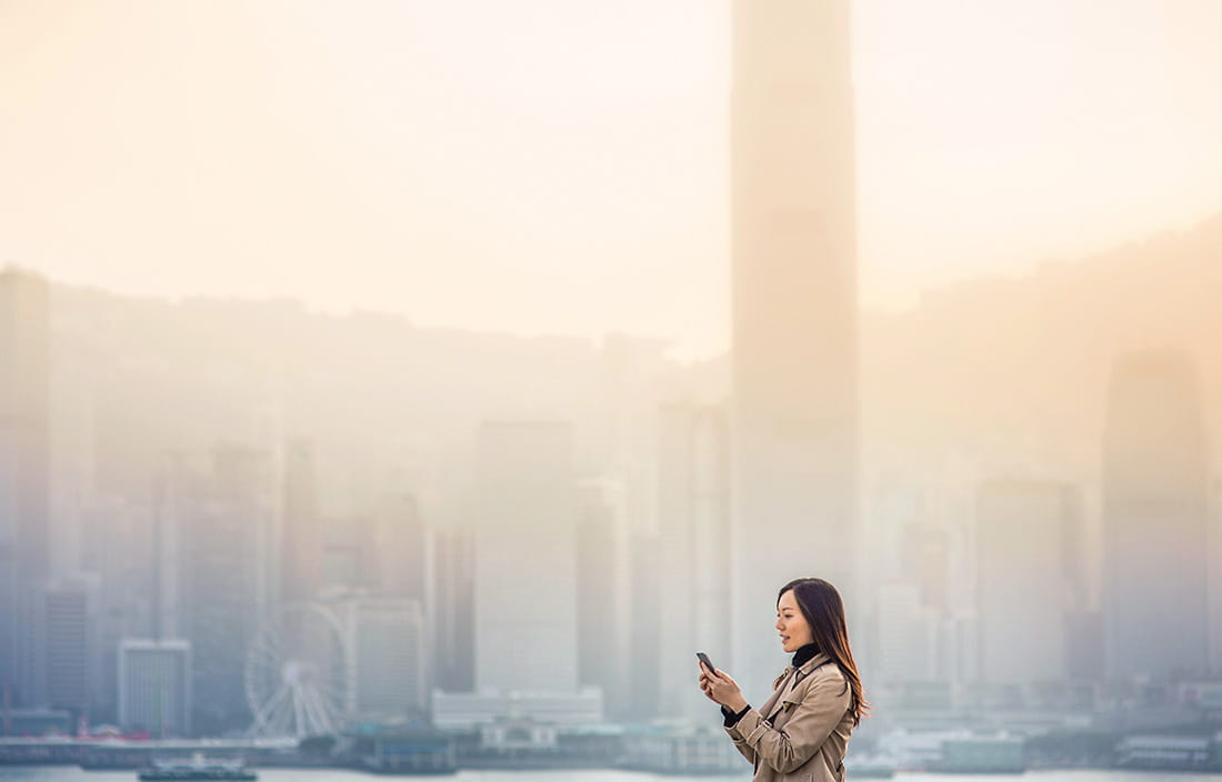 Person checking phone in a big city.