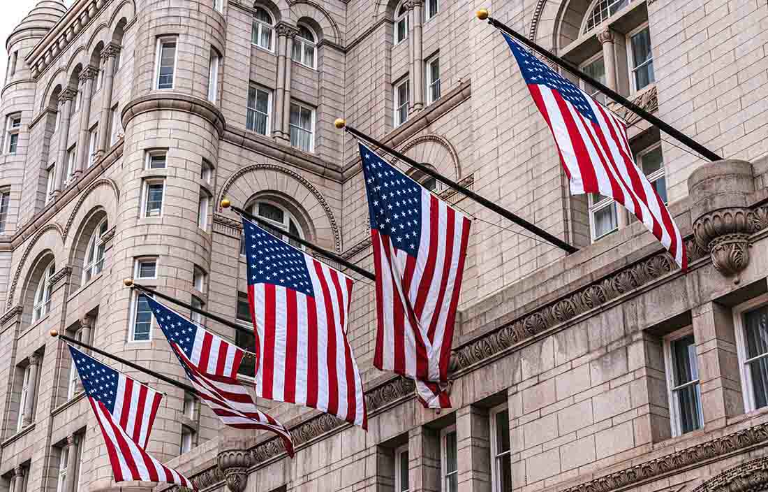 American flags outside old building.