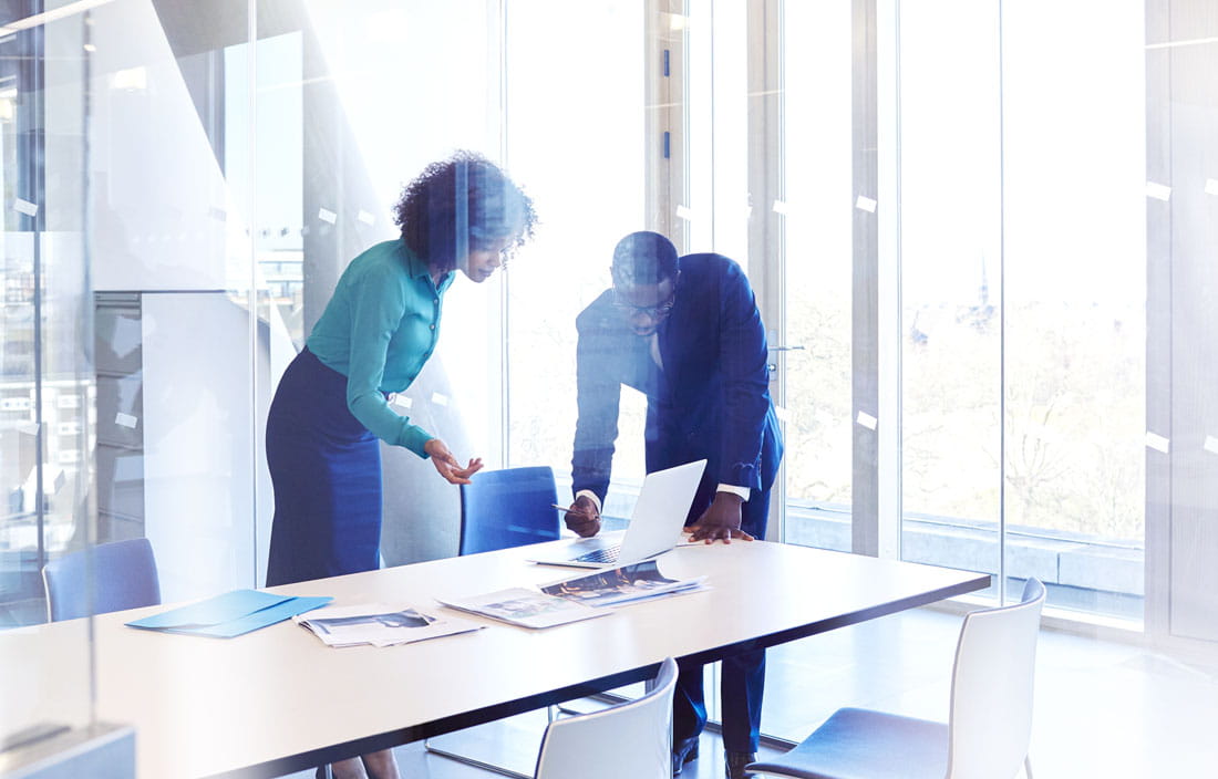 Business professionals in a modern conference room discussing international M&A.