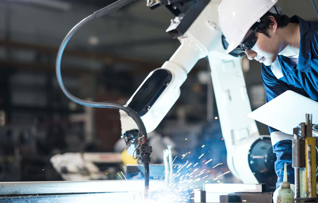 Factory worker inspecting machine.