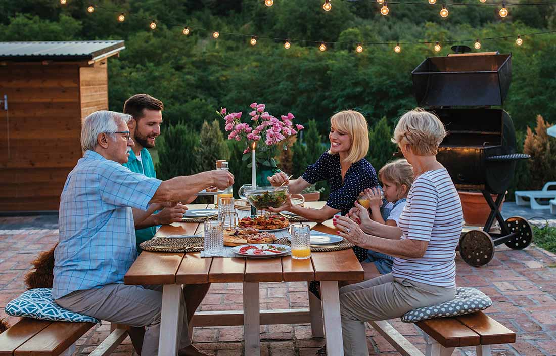 Wealthy family eating dinner together and discussing their financial legacy.