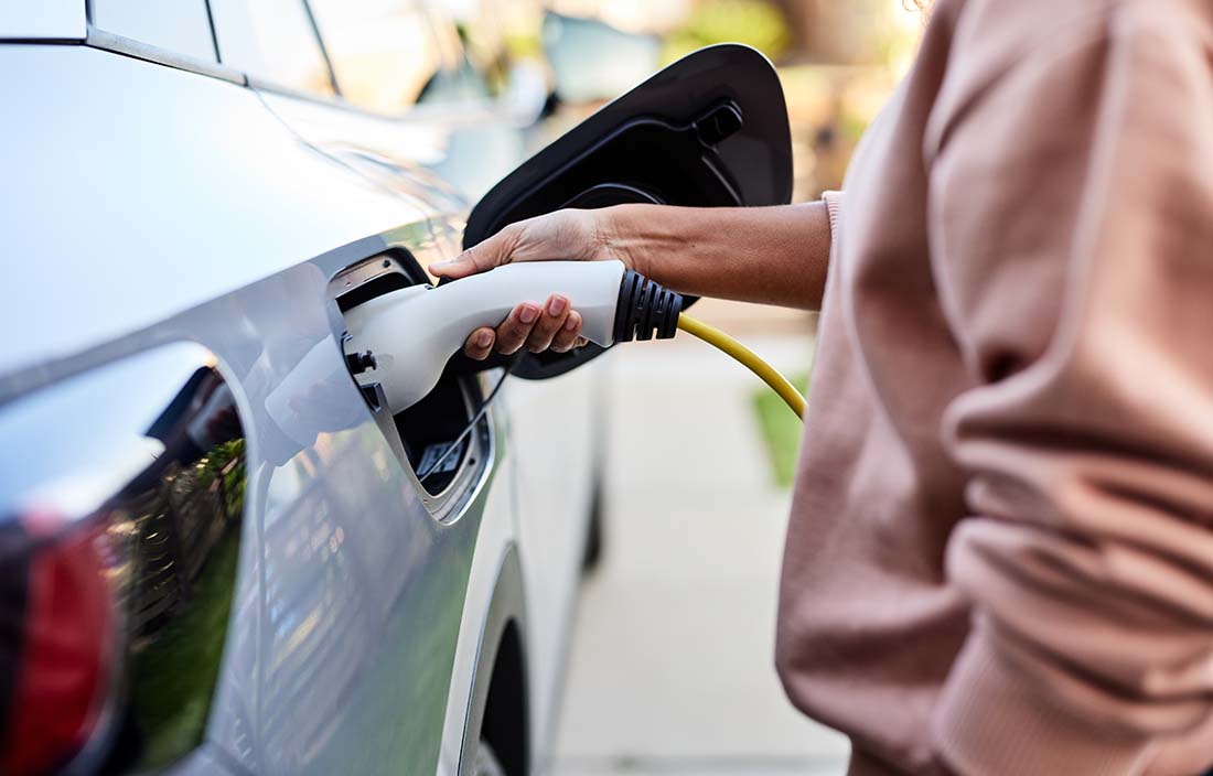 Person charging their electric vehicle.