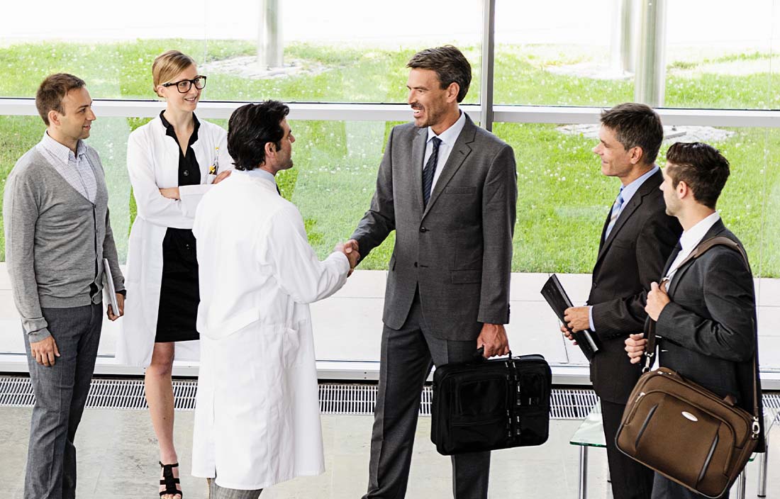 Healthcare professionals shaking hands and meeting each other.