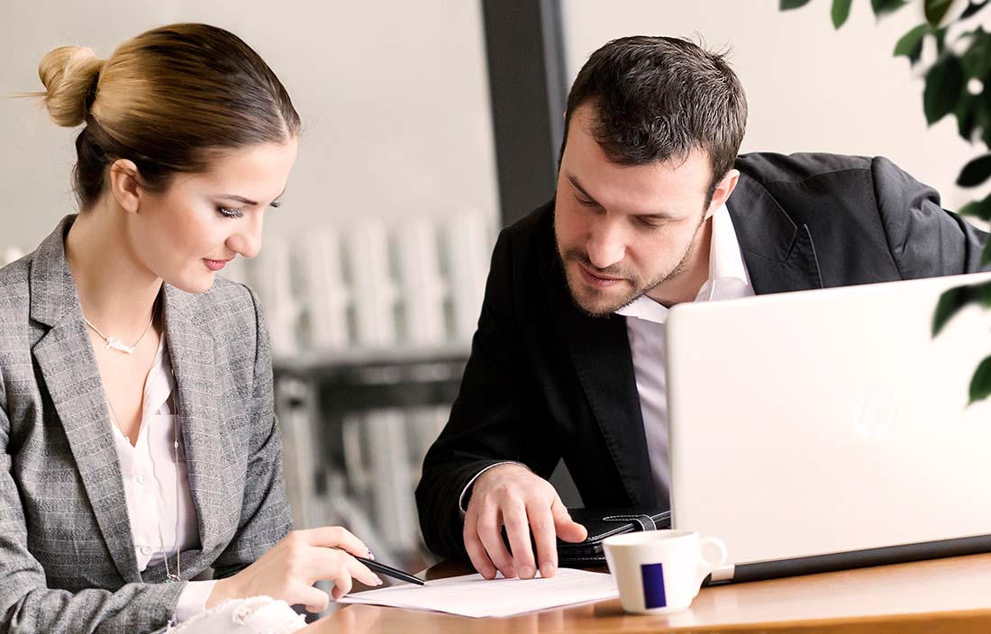 Image of businessman and business woman in a meeting.