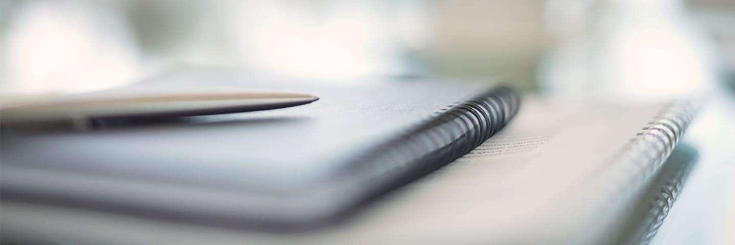 Close-up view of notebooks on a table.