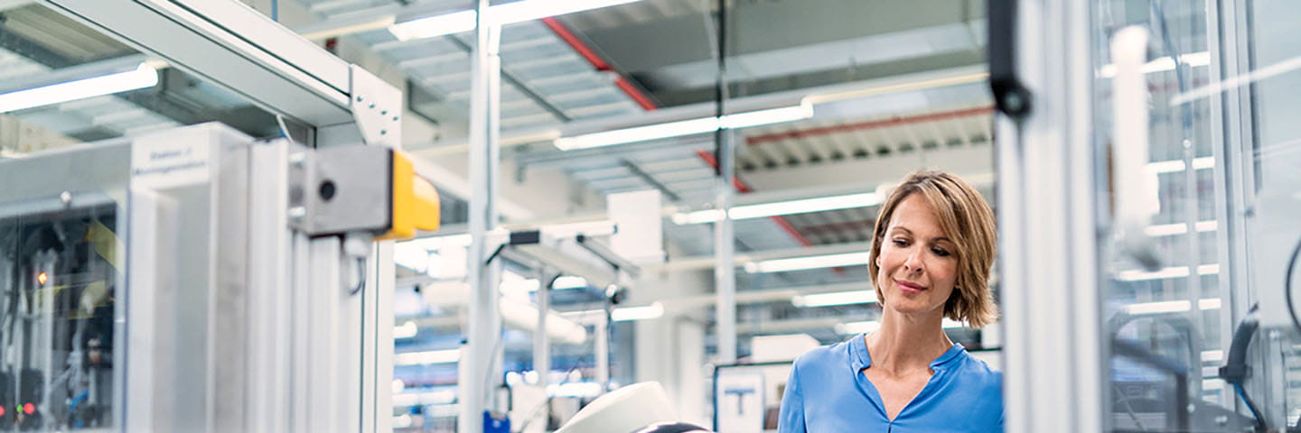 Manufacturing supervisor examining a robotic machine.