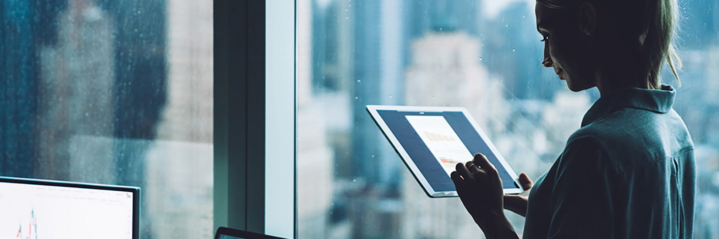 A woman using a handheld tablet device.