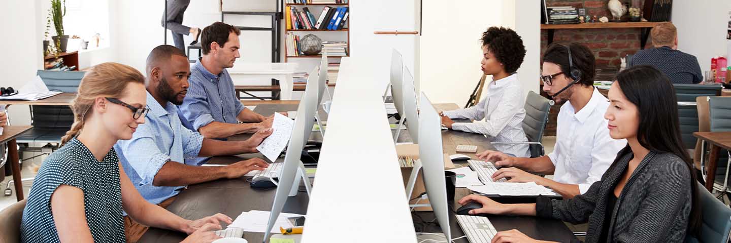 Group of people working on their computers in an office.