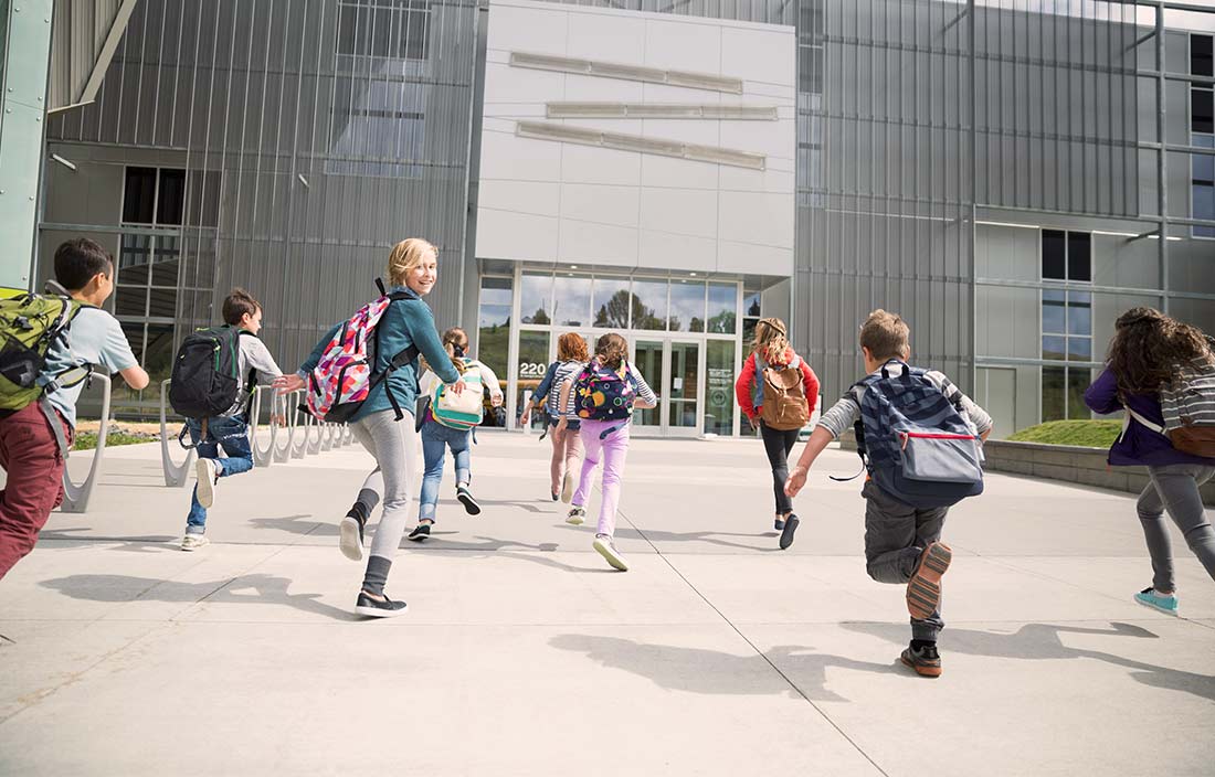 K12 children running to school.