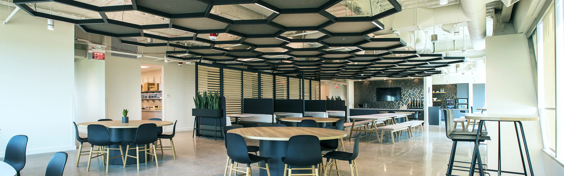 Seating area with tables in Plante Moran Southfield office.