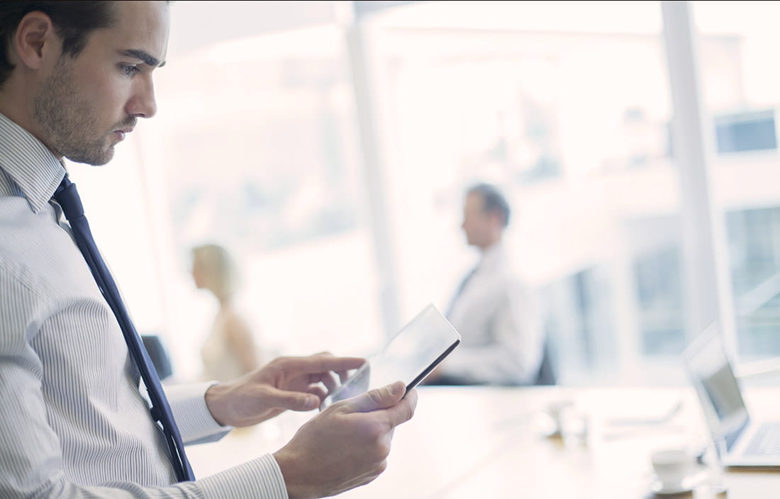 Business man looking at a tablet