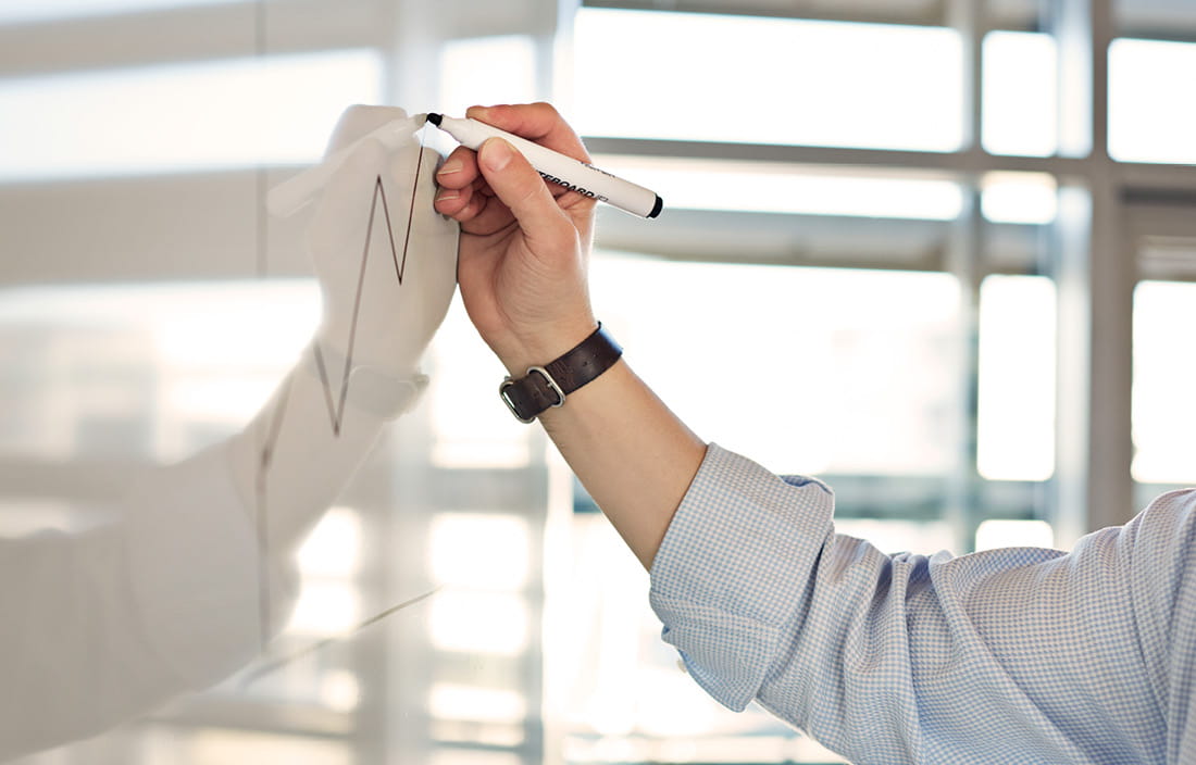 man writing on whiteboard