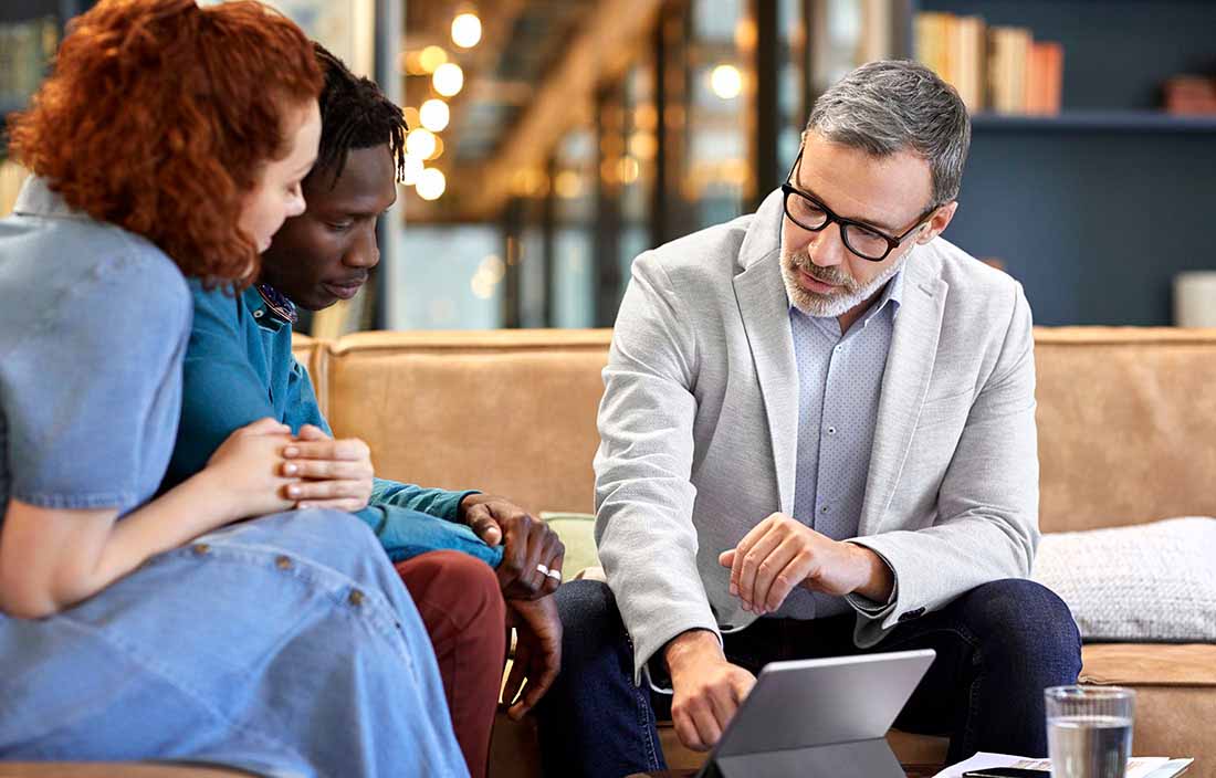 Professional trustee advising a young couple.