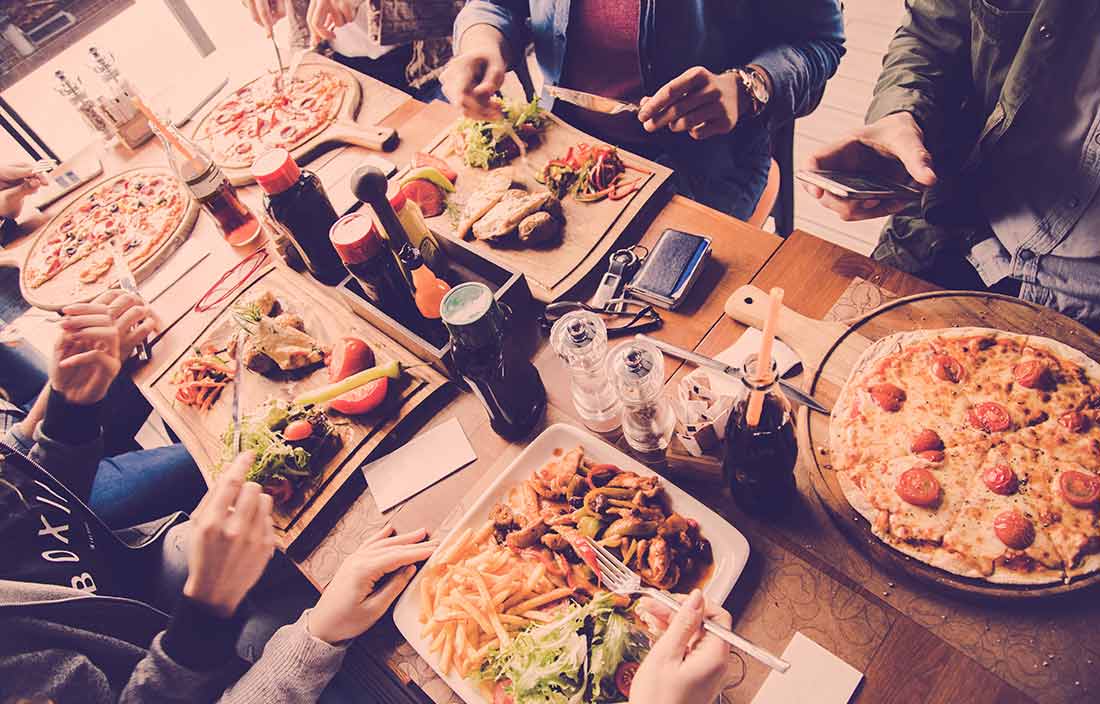 Image of a long table with plates of food.