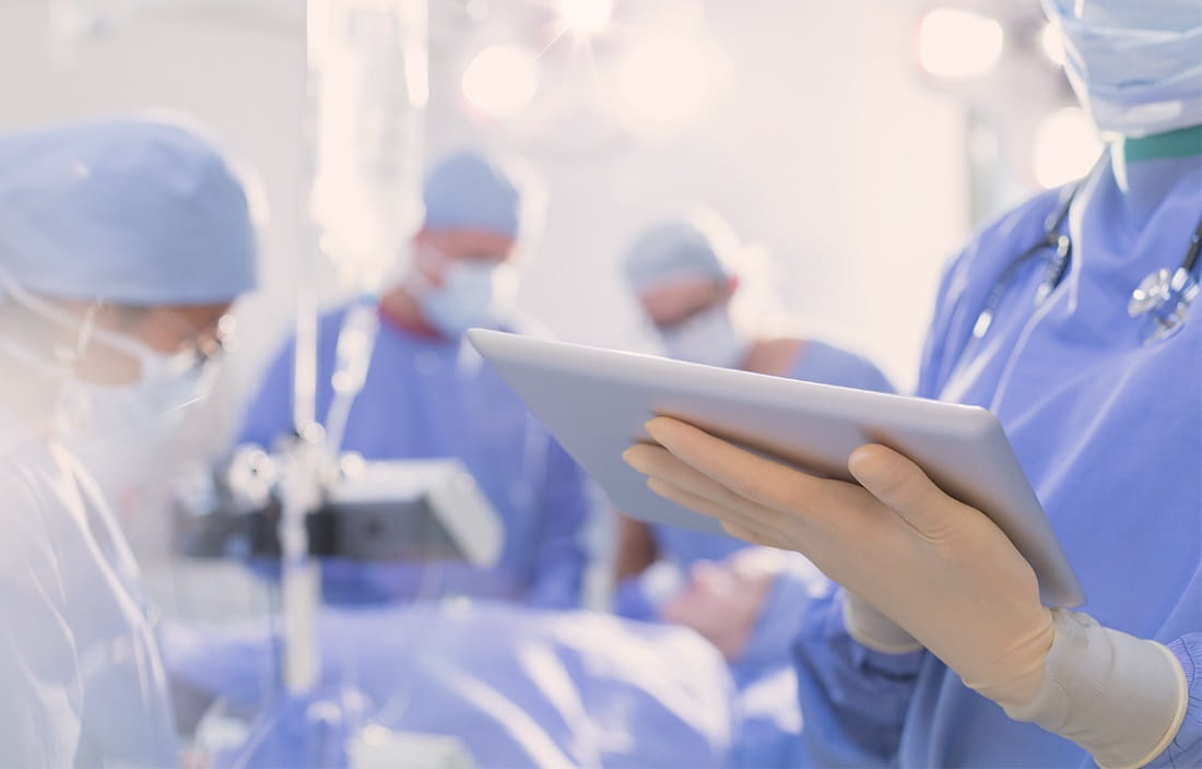 Image of medical personnel performing a procedure in an operating room.