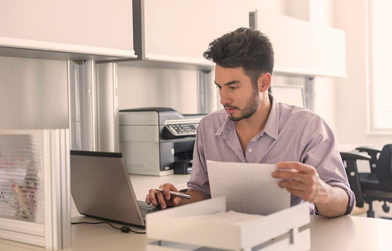 Man looking over accounting documents