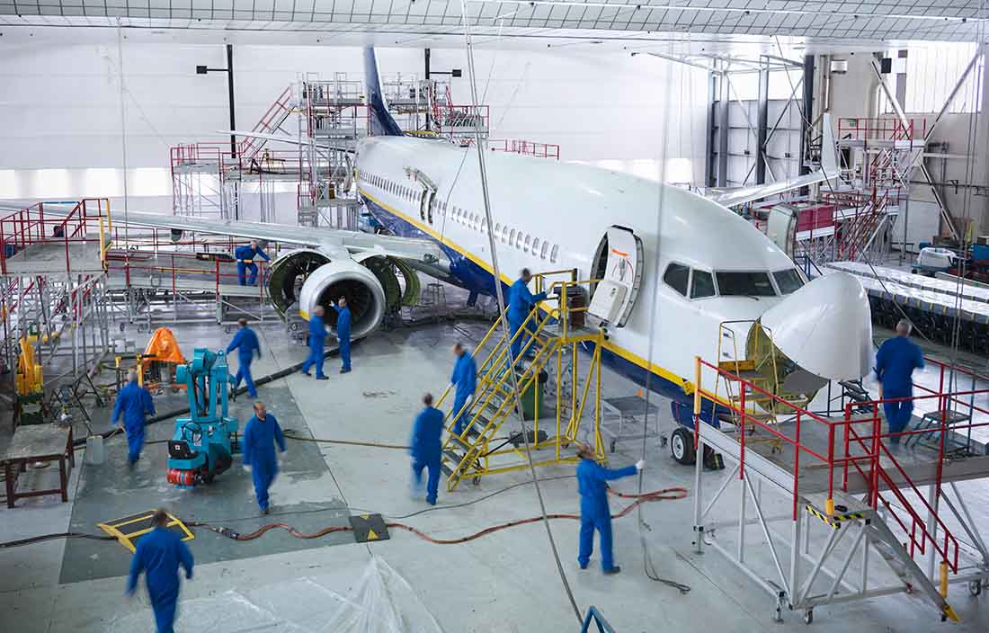 Image of engineers working on airplane. 