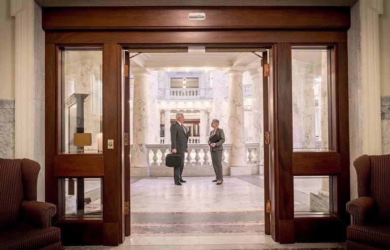 Man and woman standing in a lobby