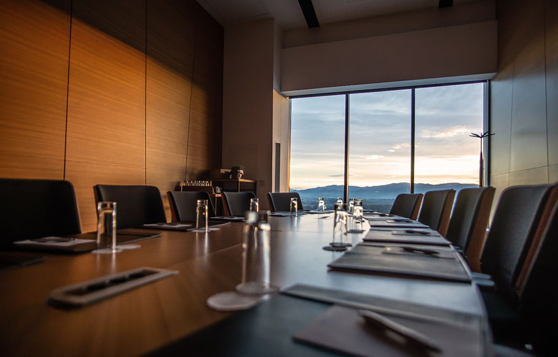 Inside a conference room with a large table and chairs