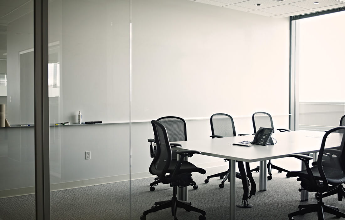 Empty conference room with a glass door entry. 