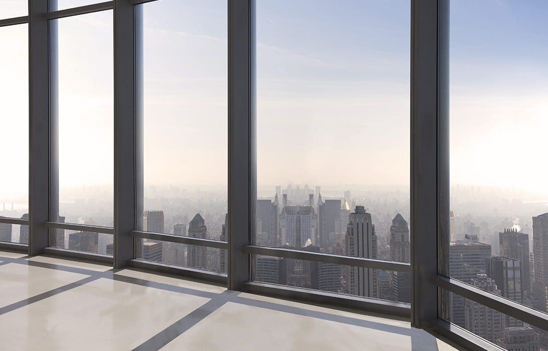 Skyline view of a city during the day looking out a window. 