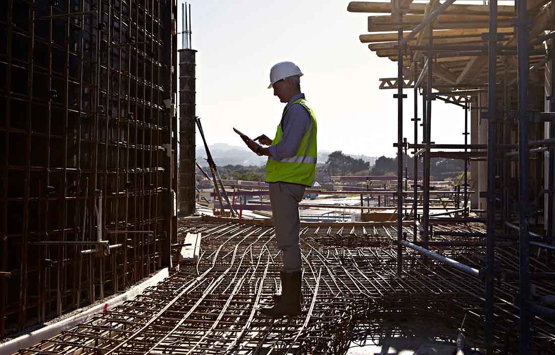 Construction worker outside on a tablet