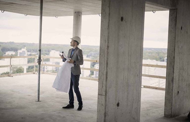 Construction inspector examining the interior of a skyscraper building.