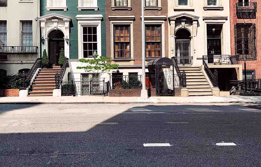 Photo of city houses lining a street.