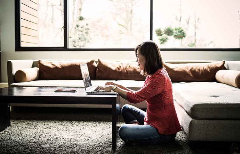 Adult working on computer from home