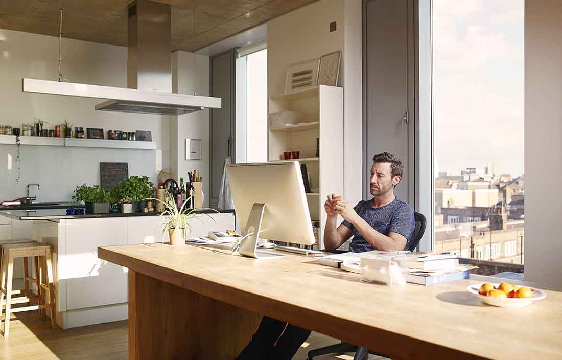 Businessman working in casual clothes in a modern home office.