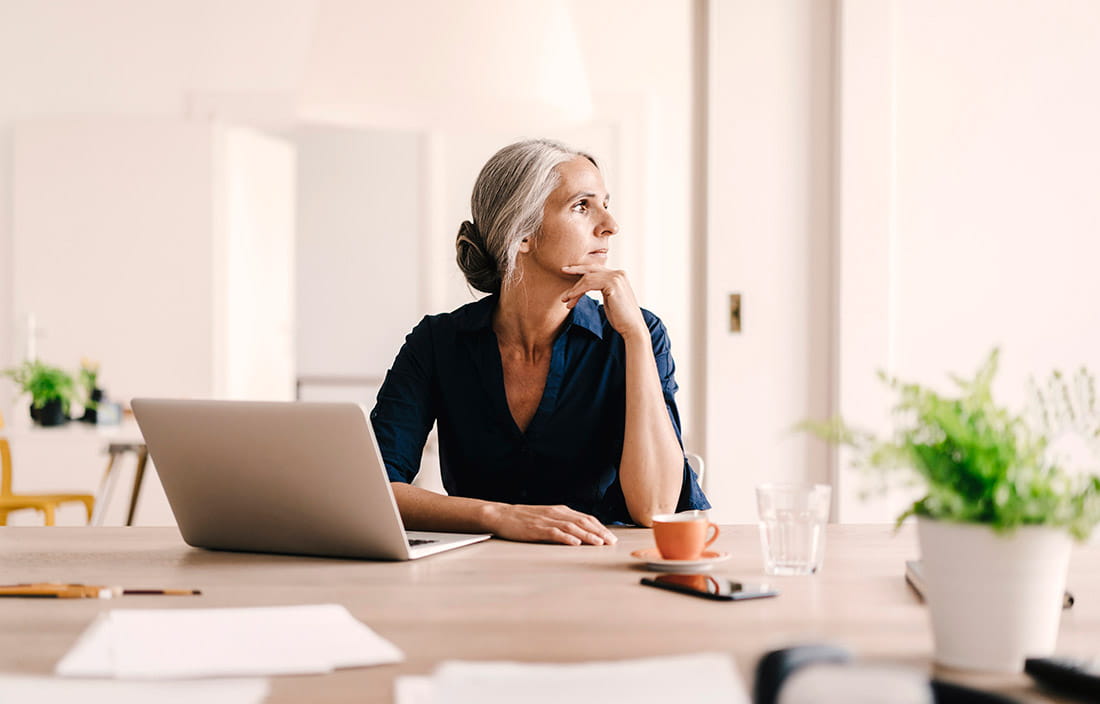 Adult looking out the window at a computer