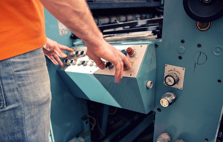 Close-up view of a machine operator operating a machine.