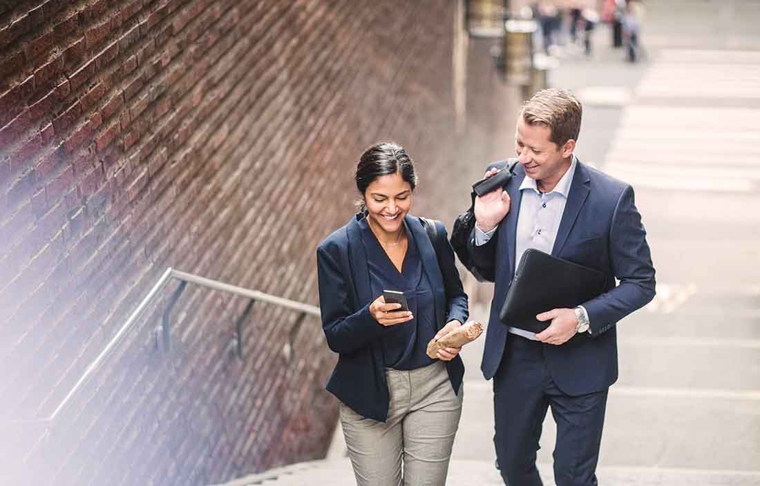 Two business professionals walking up a flight of stairs.