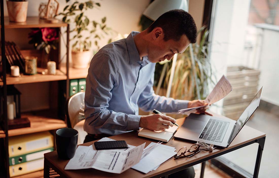 Business professional in a home office using a laptop computer.