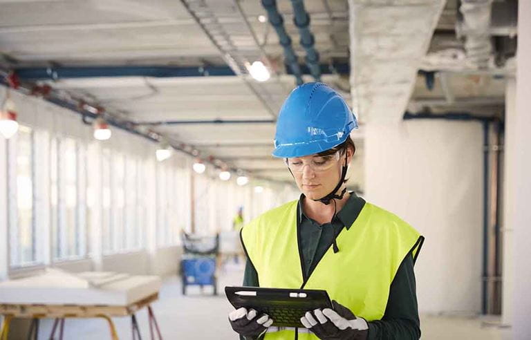 Construction worker using a tablet handheld computer.