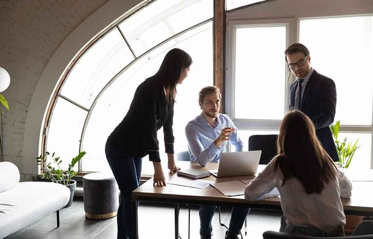 Business professionals gathered around a table.