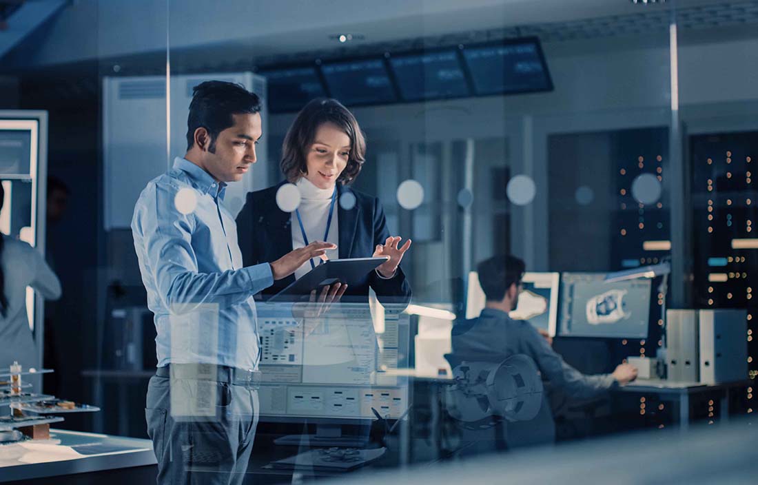 Two business professionals reviewing information together on a tablet device.