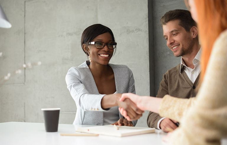 Business professionals shaking hands.