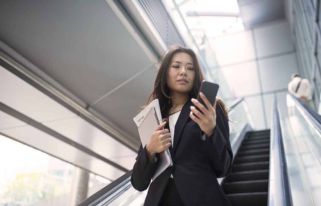 Close-up of a business professional going down stairs.