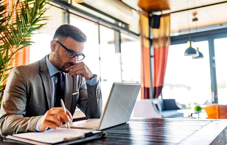 Business professional checking their laptop at a restaurant.