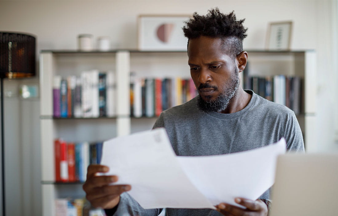 Business professional in casual clothes reviewing documents.