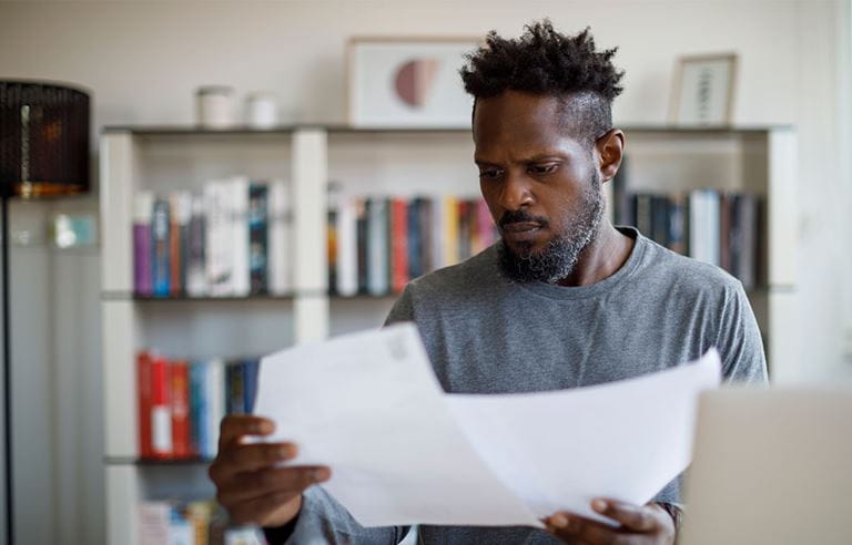 Business professional in casual clothes reviewing documents.