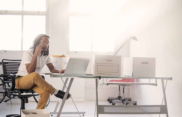 Person sitting at desk on their computer