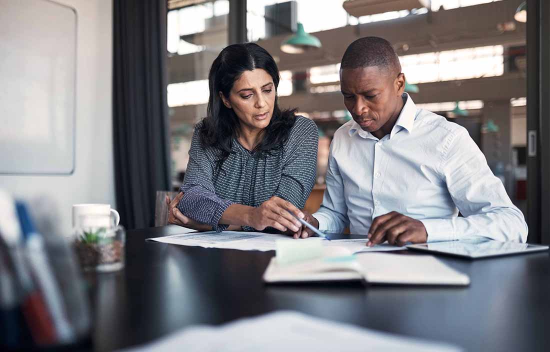 Two business professionals looking over documents.