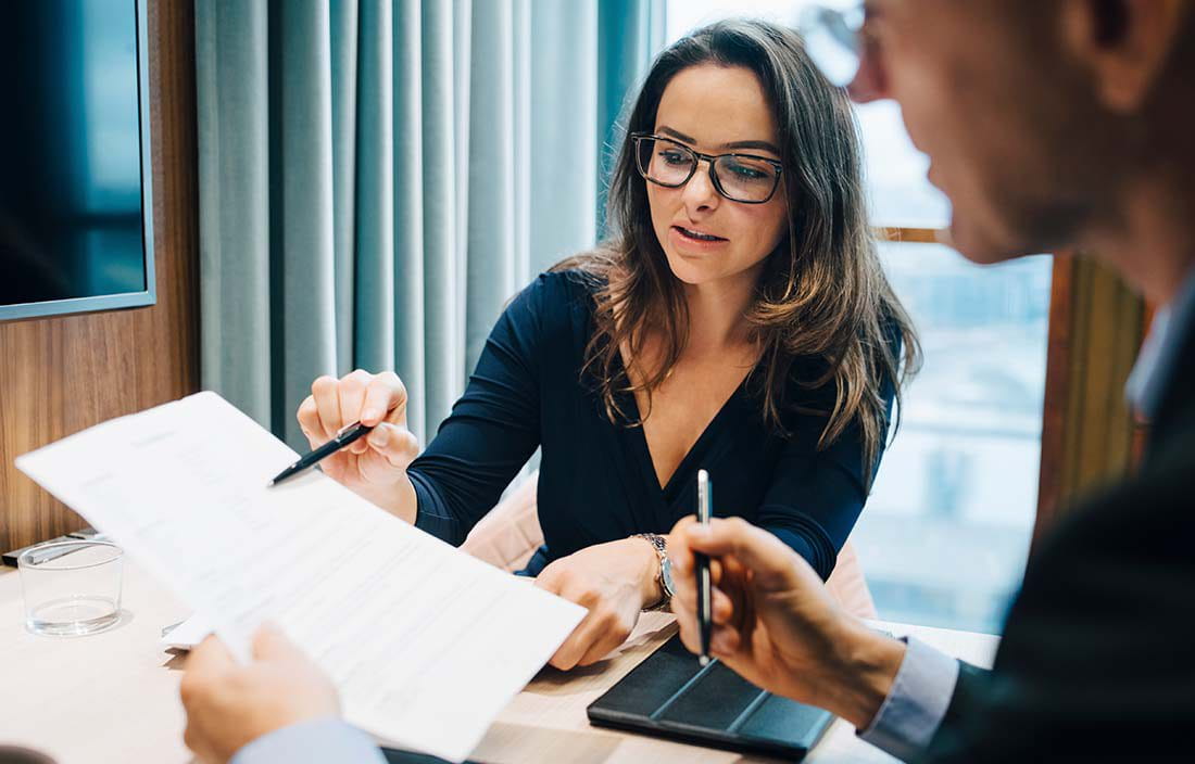 Two business professionals going over a document.